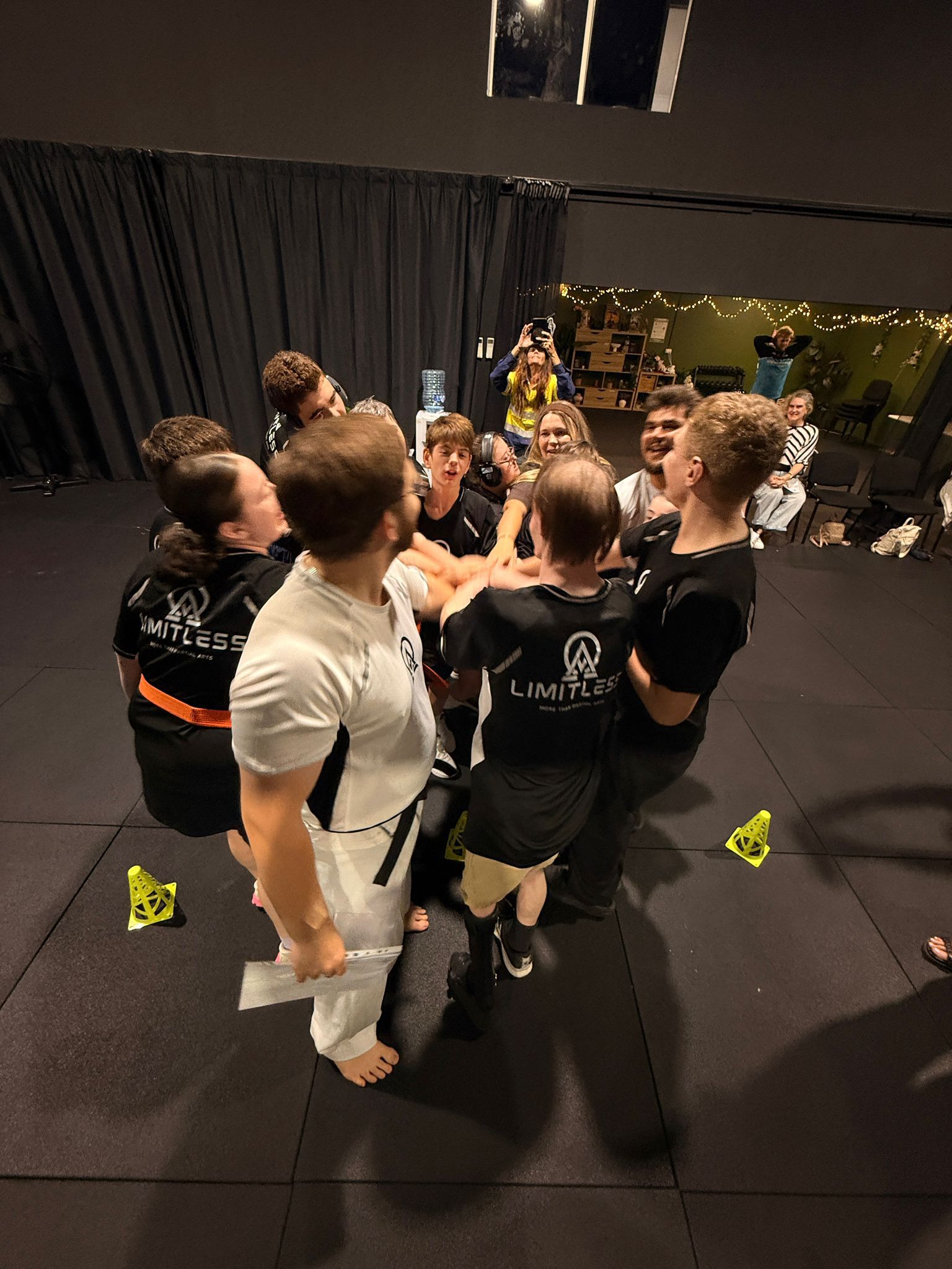 Limitless Impact students in a team huddle